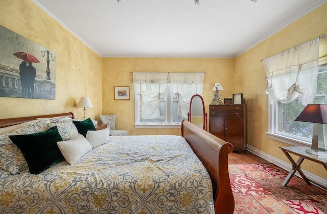 bedroom featuring hardwood / wood-style flooring and ornamental molding