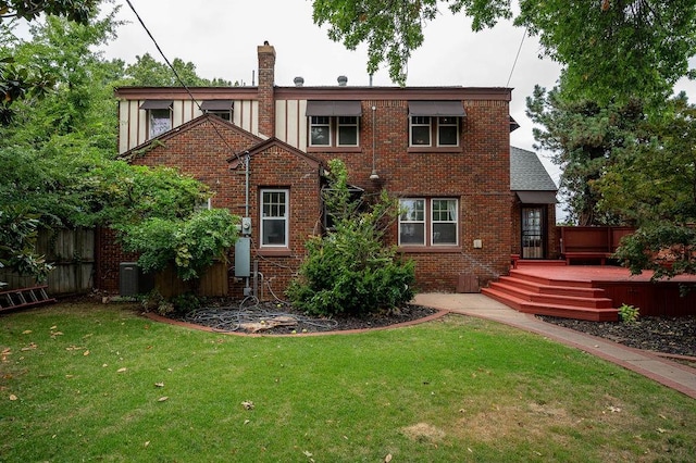 back of house with a lawn, central air condition unit, and a wooden deck