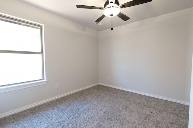 spare room featuring carpet flooring and ceiling fan