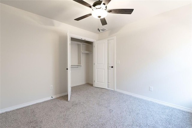 unfurnished bedroom featuring a closet, ceiling fan, and carpet