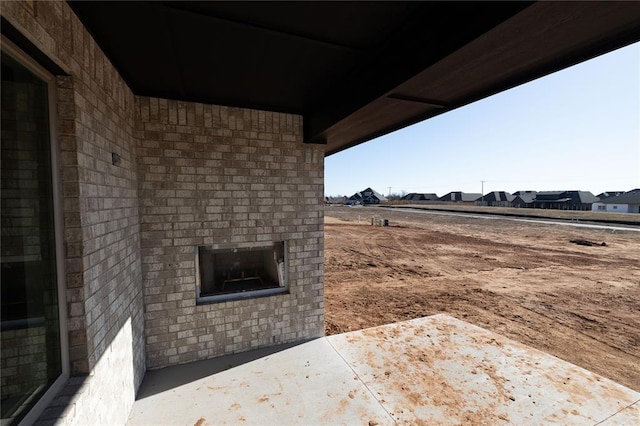 exterior space with an outdoor brick fireplace