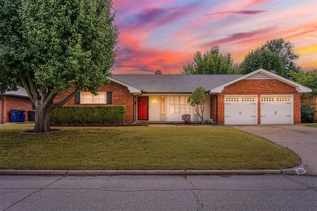 single story home featuring a yard and a garage