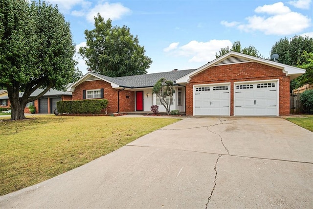 ranch-style home featuring a front lawn and a garage