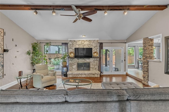 living room with wood-type flooring, lofted ceiling with beams, a wealth of natural light, and ceiling fan