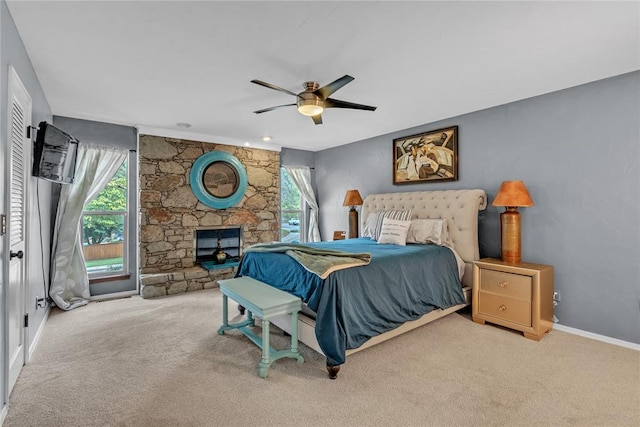 carpeted bedroom featuring multiple windows and ceiling fan