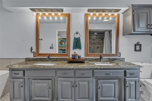 full bathroom with vanity, ceiling fan, toilet, and plus walk in shower