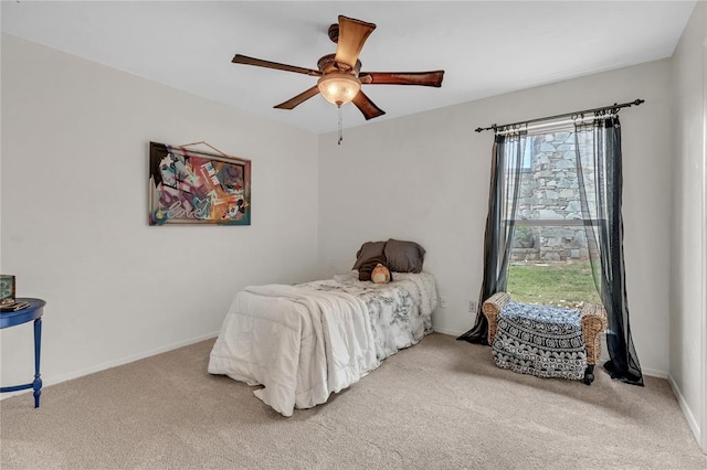 bedroom with multiple windows, ceiling fan, and carpet floors