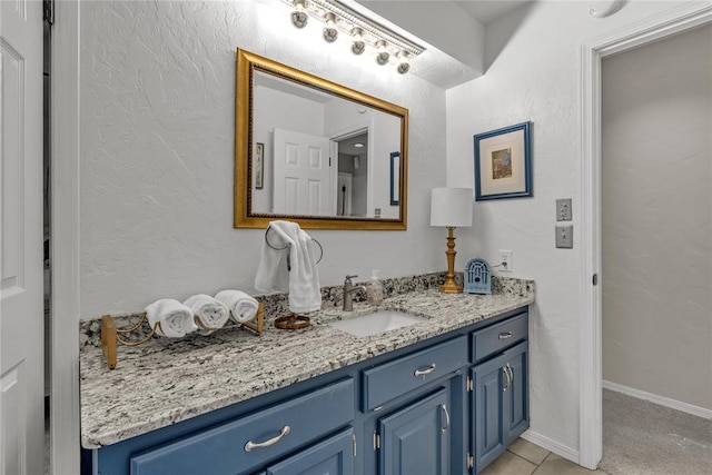 bathroom with tile patterned floors and vanity