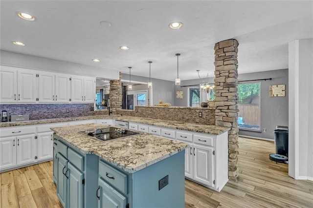 kitchen with blue cabinetry, white cabinetry, a kitchen island, and stainless steel gas stovetop