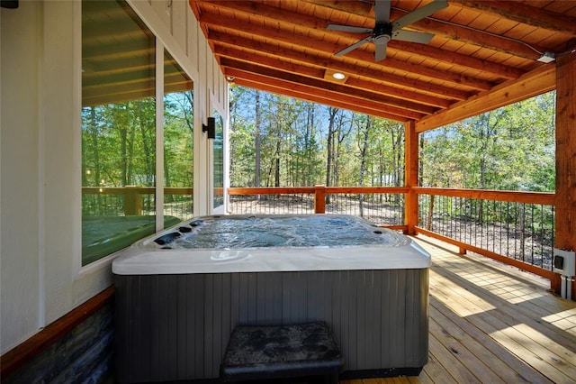 deck featuring ceiling fan and a hot tub