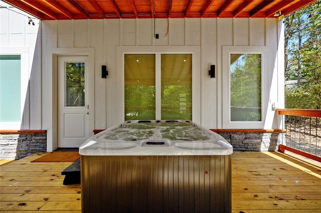 wooden deck with a hot tub