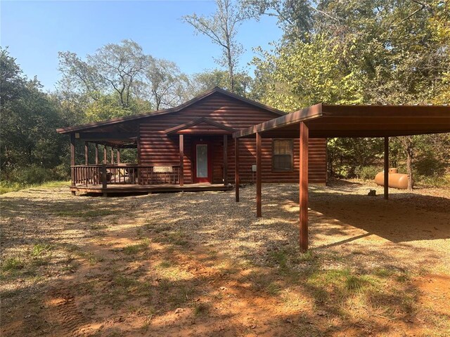 view of front of home featuring a carport and a wooden deck