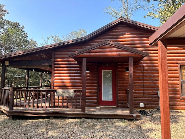 view of exterior entry with a deck