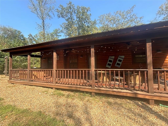 rear view of property featuring ceiling fan