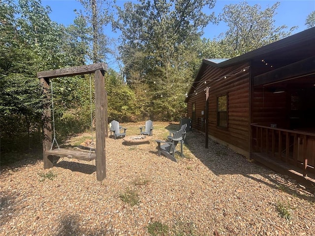 view of yard featuring an outdoor fire pit