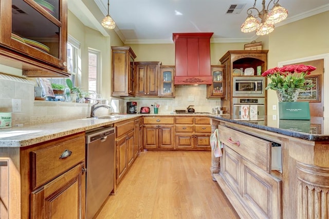 kitchen with decorative light fixtures, light hardwood / wood-style floors, premium range hood, and stainless steel appliances