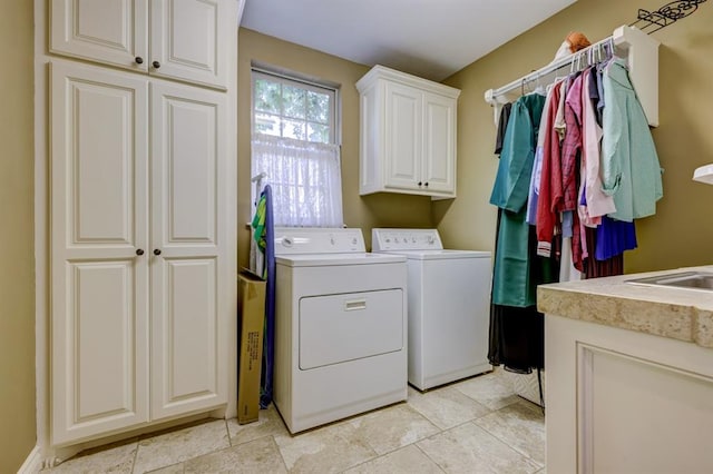 washroom with cabinets and independent washer and dryer