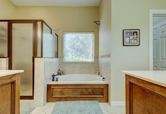 bathroom featuring tile patterned flooring, shower with separate bathtub, and vanity