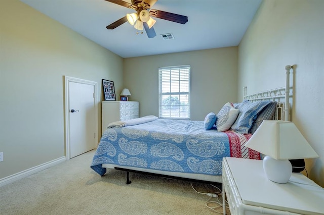 bedroom with ceiling fan and light colored carpet