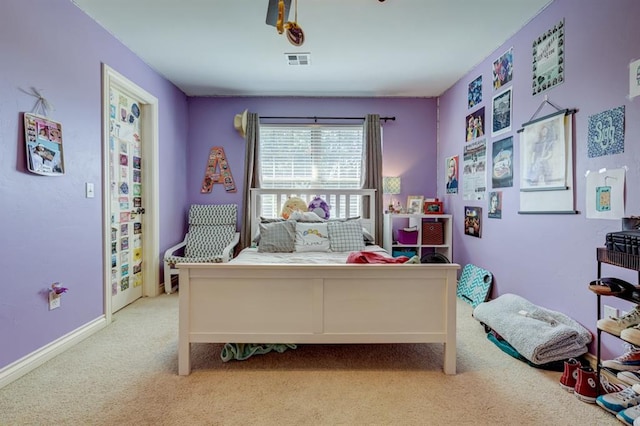 bedroom featuring light colored carpet