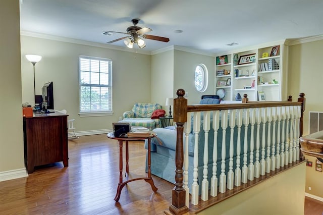 living area featuring crown molding, ceiling fan, and dark hardwood / wood-style floors