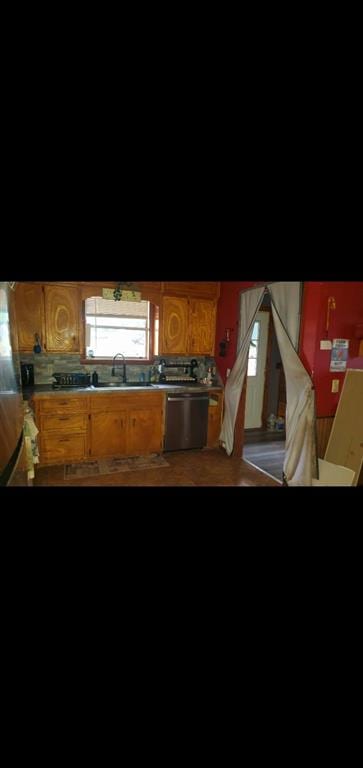 kitchen featuring sink, stainless steel dishwasher, and wood-type flooring