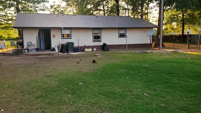 rear view of property with a lawn