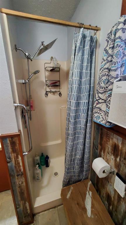 bathroom with tile patterned floors and curtained shower