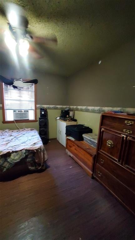 bedroom featuring ceiling fan and dark hardwood / wood-style floors