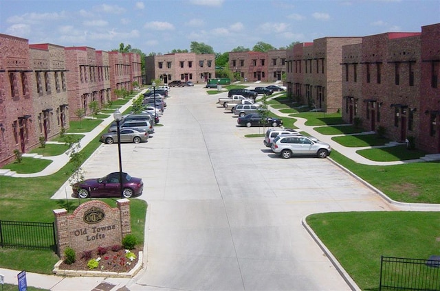 view of community with uncovered parking
