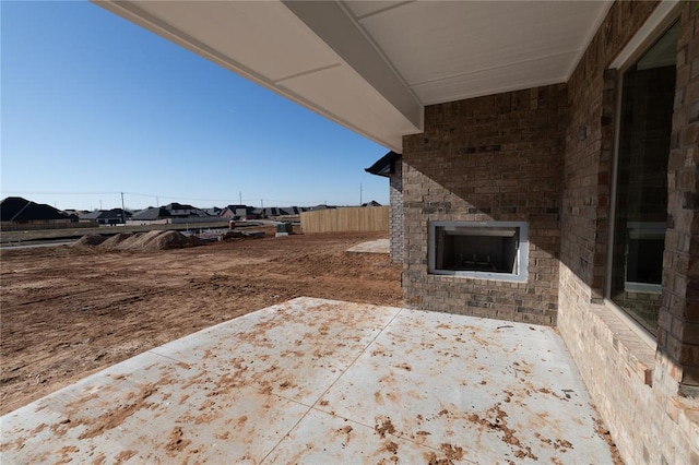 view of patio featuring an outdoor brick fireplace