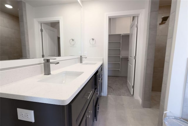 bathroom with vanity and tiled shower