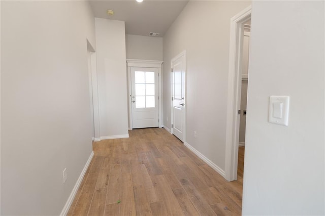 corridor with light hardwood / wood-style floors