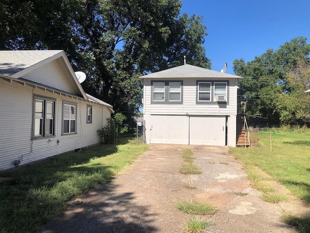 view of side of home featuring a yard and a garage