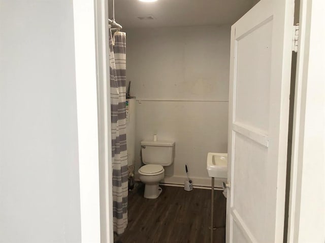 bathroom featuring toilet and hardwood / wood-style flooring