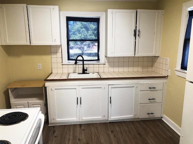 kitchen featuring backsplash, dark hardwood / wood-style floors, white cabinetry, and sink