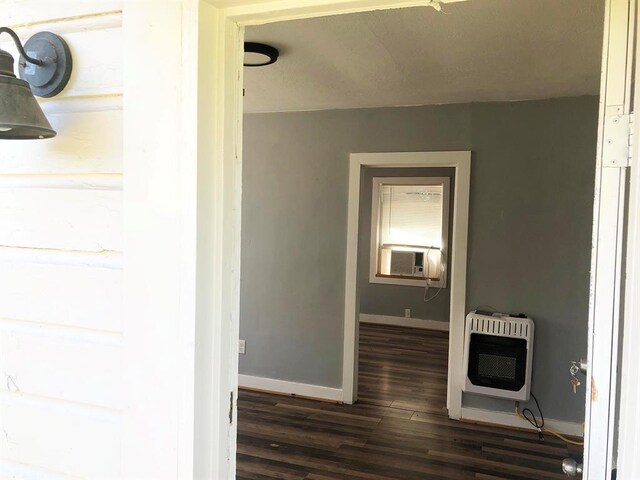 hall featuring cooling unit, dark hardwood / wood-style flooring, and heating unit