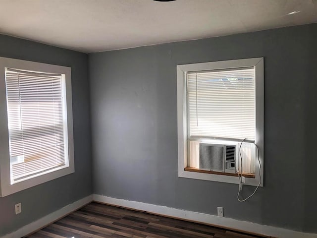 unfurnished room featuring cooling unit and dark wood-type flooring