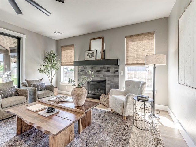 living room featuring ceiling fan and hardwood / wood-style floors