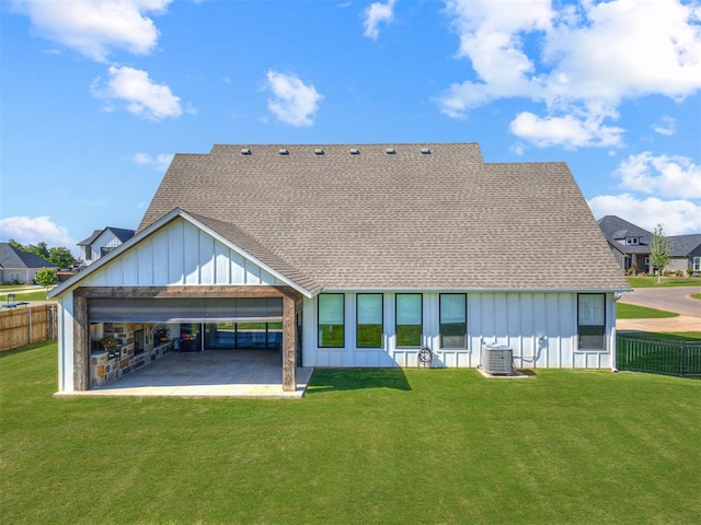 back of property featuring a patio area, a yard, and central AC