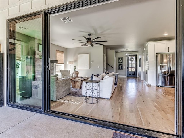 living room featuring hardwood / wood-style floors and ceiling fan