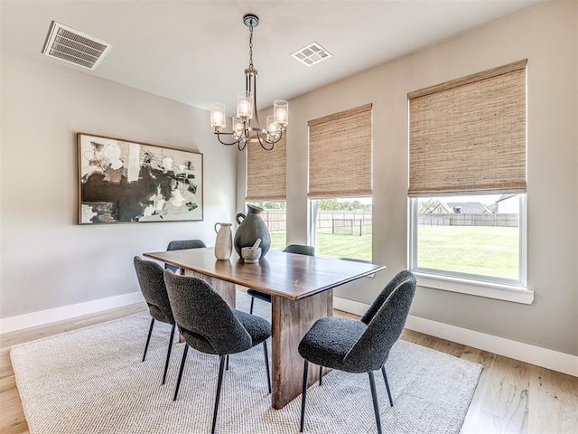 dining room featuring light hardwood / wood-style floors and an inviting chandelier