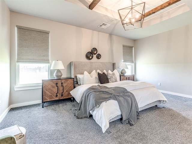 bedroom featuring carpet flooring, multiple windows, and a chandelier