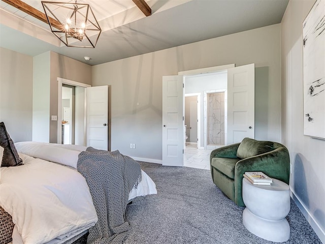 bedroom featuring a notable chandelier, carpet floors, and connected bathroom