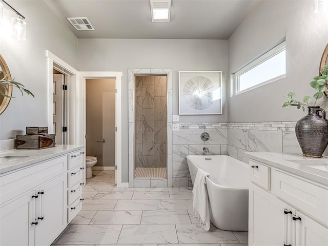 full bathroom with vanity, toilet, tile walls, and independent shower and bath