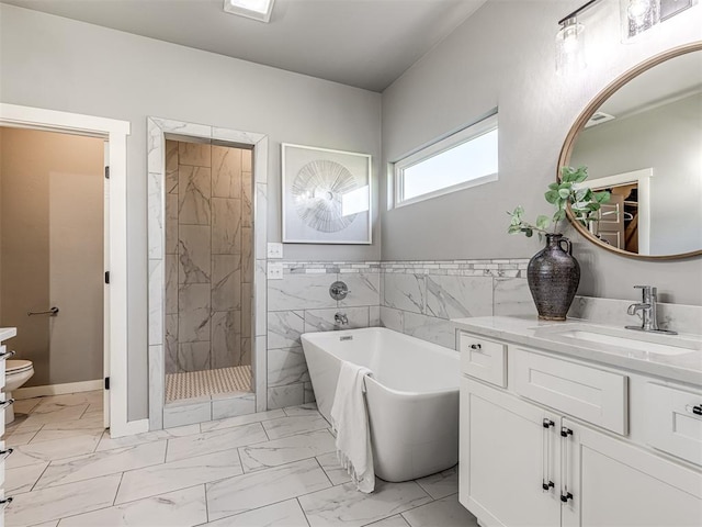 full bathroom with separate shower and tub, vanity, tile walls, and toilet