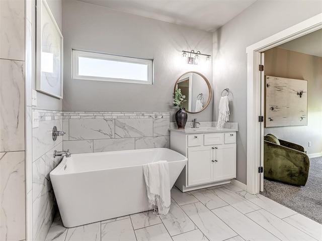 bathroom featuring a bathtub, tile walls, and vanity