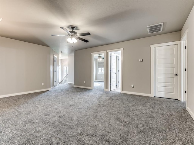 spare room featuring ceiling fan and carpet