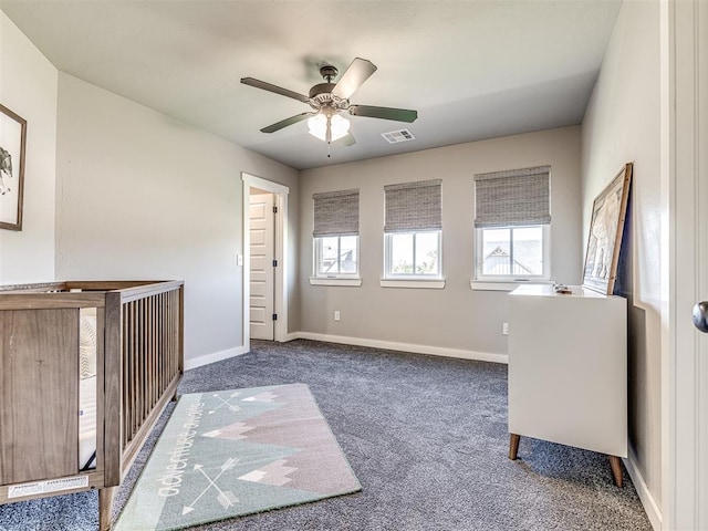 unfurnished bedroom featuring ceiling fan and dark carpet