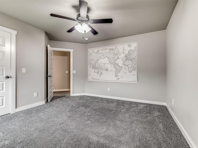 carpeted spare room featuring ceiling fan